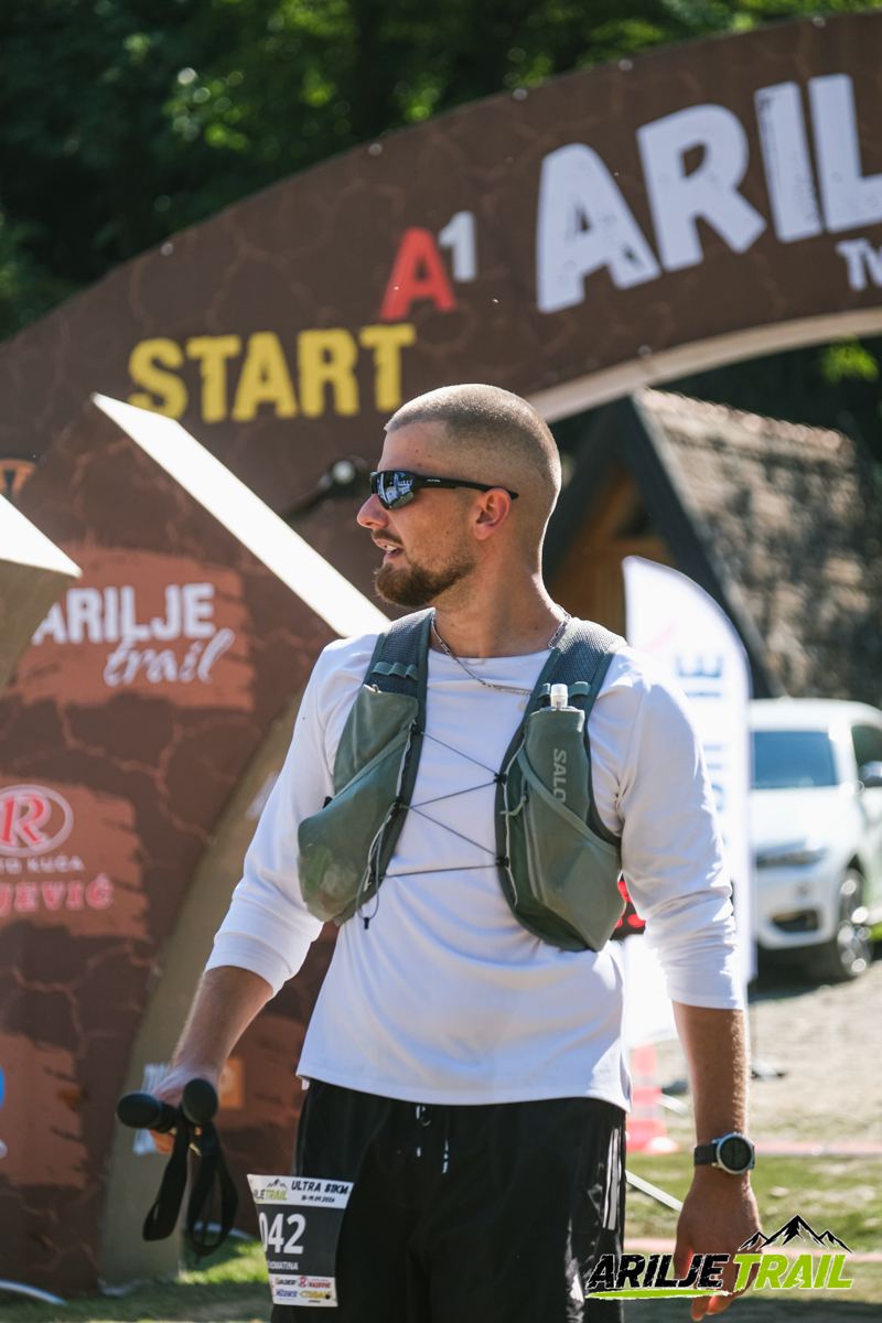 Uroš at the Arilje Trail 81K start line with his race vest and poles
